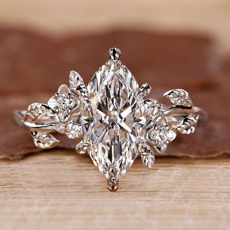 Marquise cut diamond ring with round side stones.