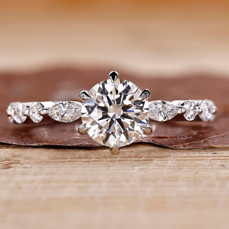 Round cut diamond ring set in a classic white gold band with elegant detail.