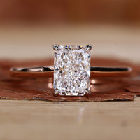 Radiant cut diamond ring in a sleek four prong claw setting.