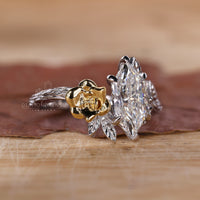 Two tone engagement ring with nature inspired design and Dutch marquise diamond.