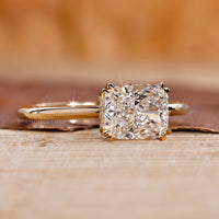 Hidden halo diamond ring with elongated cushion centre stone.