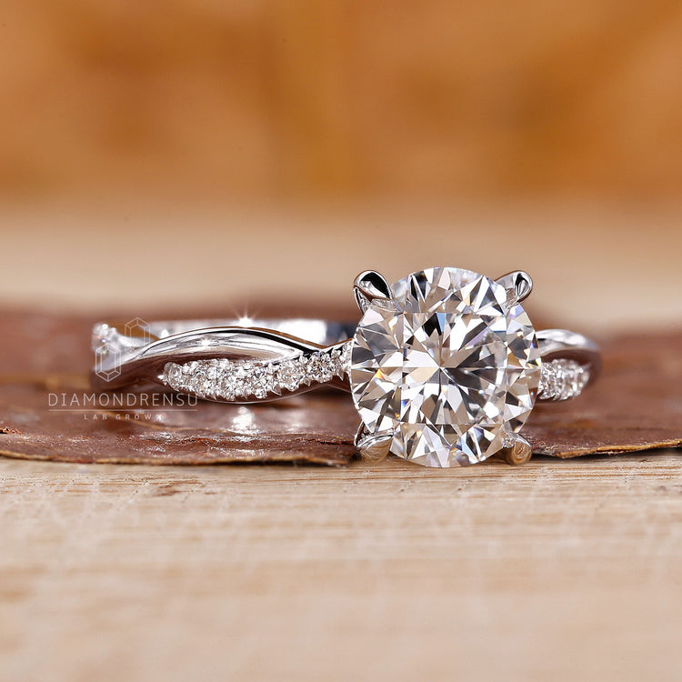 Round diamond pave setting crafted in white gold with handmade detailing.