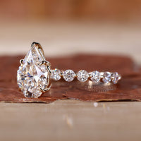 Unique engagement ring featuring a teardrop spear cut diamond with a pave diamond setting.