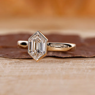 Bezel set ring with hexagon cut diamond.