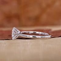 White gold ring made with compass prong setting.