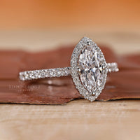Round cut halo setting white gold engagement ring.