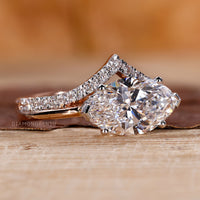 V shaped ring setting with marquise diamond in white and rose gold.