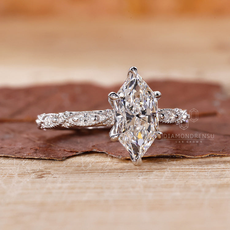 6 claw prong setting on round cut side stones.
