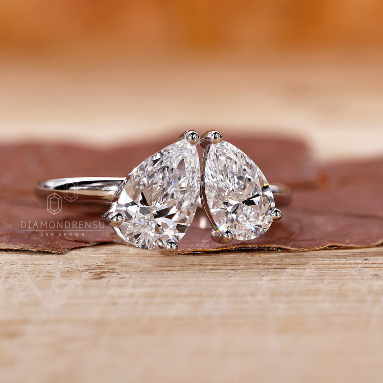 Prong setting ring with pear cut lab grown diamonds.