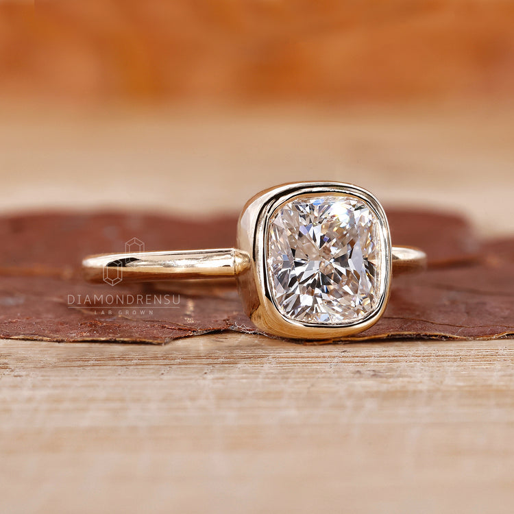Yellow gold engagement ring in cushion cut engagement ring style.