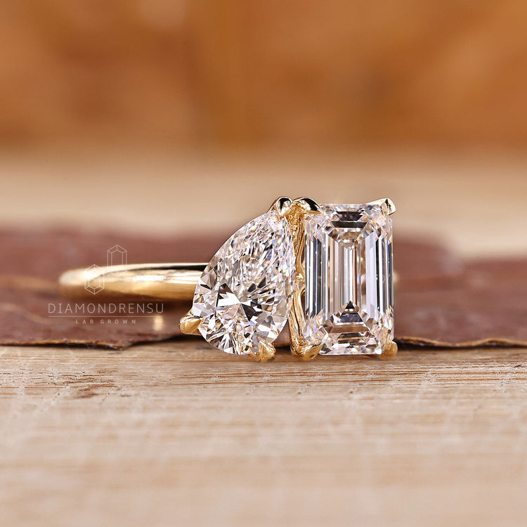 2 stone diamond ring and emerald and pear cut ring.