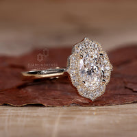 Intricate vintage halo ring featuring a central round diamond surrounded by smaller gems.