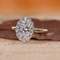 Two tone oval cut diamond engagement ring.