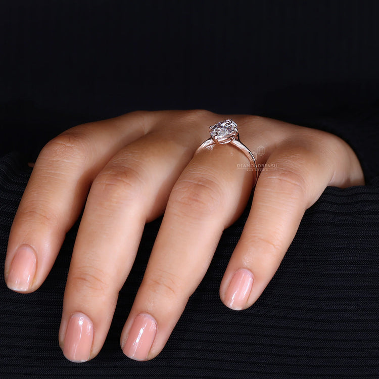 Handmade ring with a marquise diamond set in a rose gold compass prong setting.