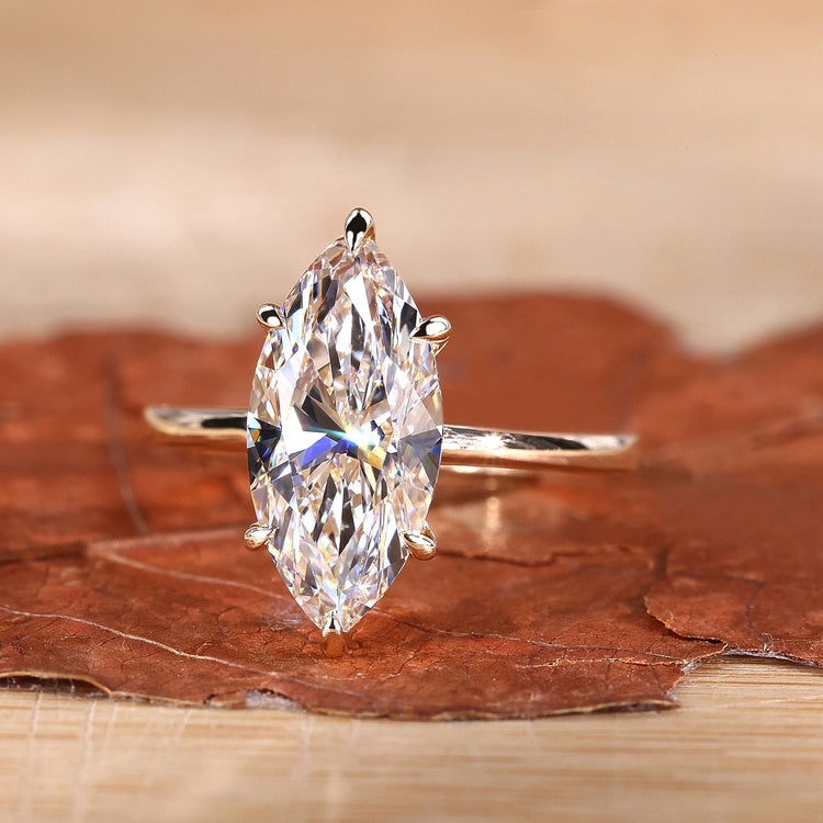 Marquise engagement ring in yellow gold with a 6 claw prong setting.