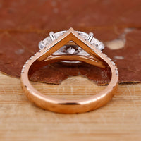 Rose gold ring with V shaped marquise diamond and two tone style.