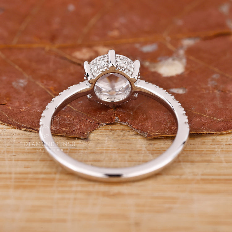 White gold ring with pavé diamonds and hidden halo design.