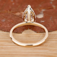 Lab grown pear diamond solitaire engagement ring.