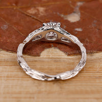 Solitaire setting ring with round diamond and claw prongs.