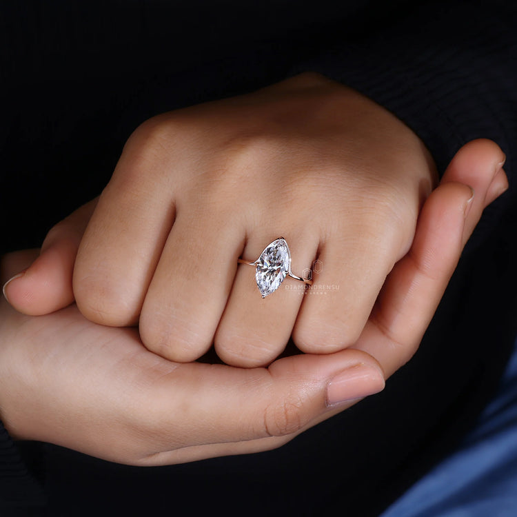 Solitaire Diamond Ring with marquise diamond set in rose gold.