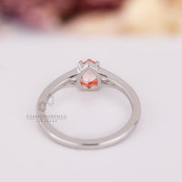 Custom diamond ring with pink pear cut stone and split shank.