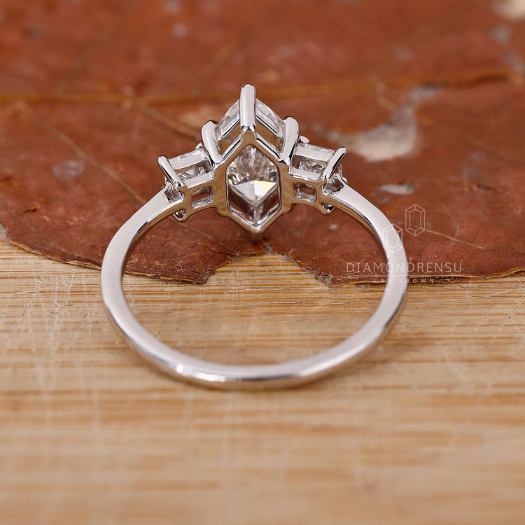 Buy Engagement ring featuring princess cut side stones.