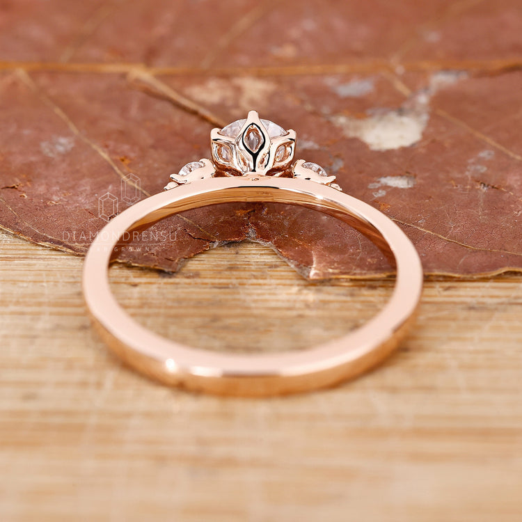 Rose gold engagement ring with three stone engagement ring.