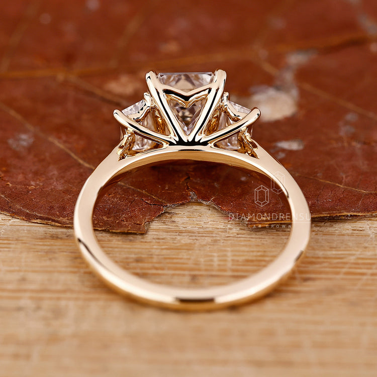 Buy Engagement ring with trapezoid side stone.