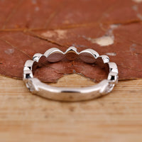 White gold wedding band with bezel setting.