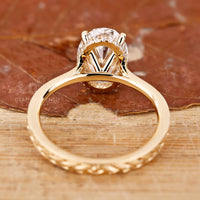 Handmade jewellery piece with custom halo and round diamond detailing.