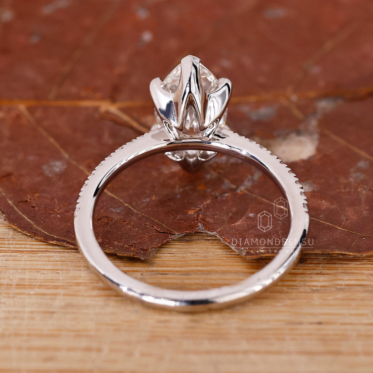 White gold ring with a marquise diamond and handmade detailing.