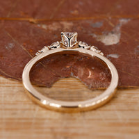 Shared prong engagement ring with round diamonds.