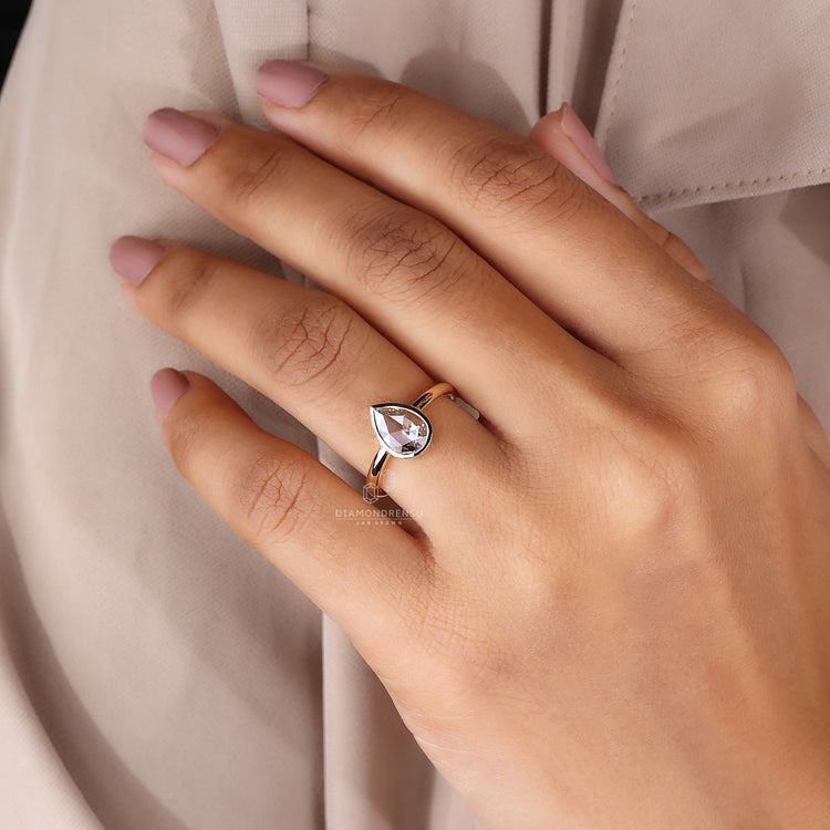 Yellow gold bezel engagement ring with custom design.