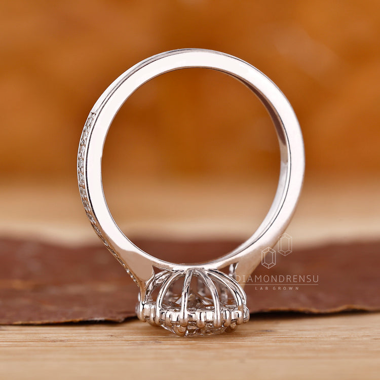 White Gold Ring with halo and round diamond accents.