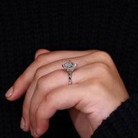 Compass prong setting on white gold engagement ring.