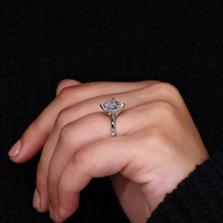 Compass prong setting on white gold engagement ring.