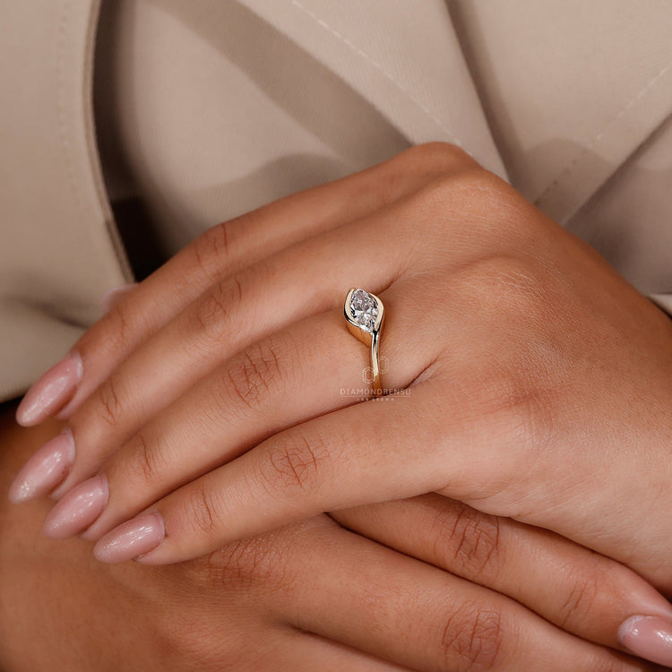 Unique east west engagement ring in yellow gold for a modern look