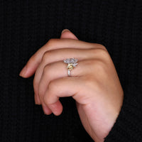 Round side stone ring with Dutch marquise diamond in two tone gold.