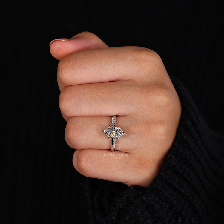 Marquise and round side stone on cathedral setting ring.