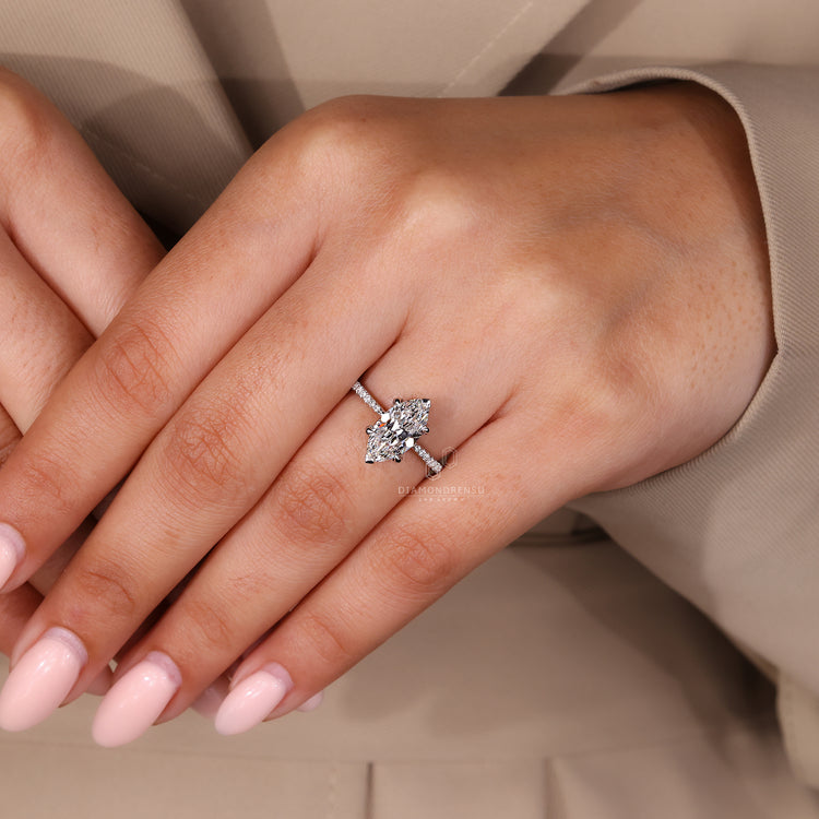 Custom diamond ring featuring v prong and pave setting with lab grown stones.