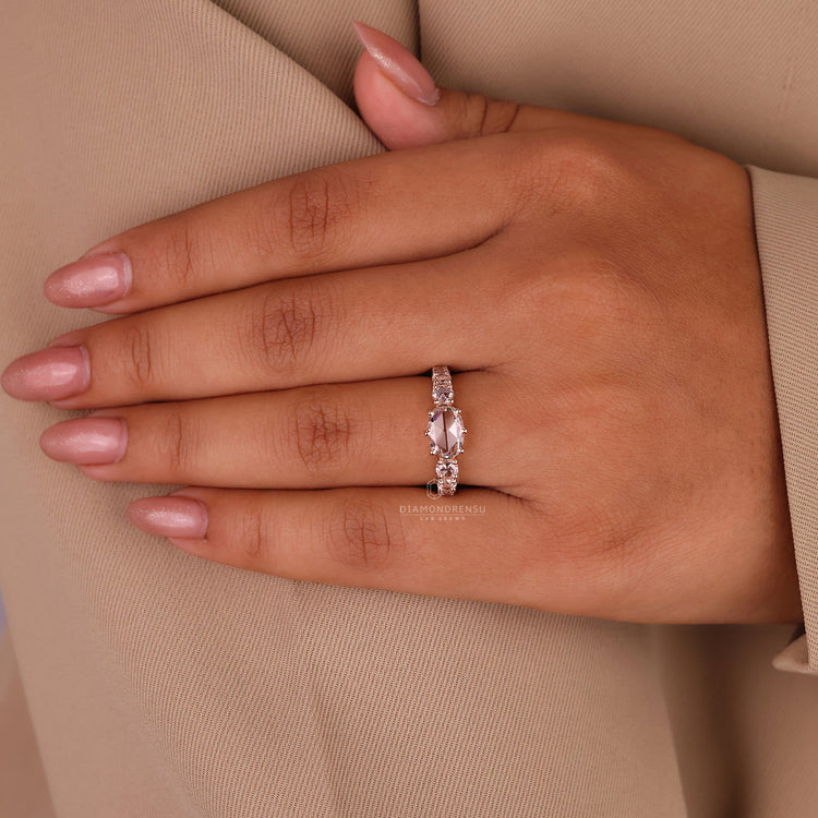 Round rose cut side stone ring with prong setting in rose gold.