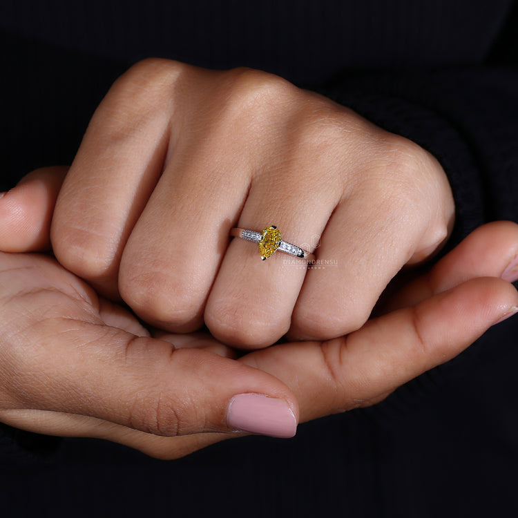 Yellow diamond ring with compass prong setting.