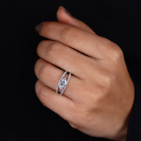East west engagement ring with round diamond accents.