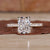 Radiant cut diamond ring with pave diamonds in yellow gold, featuring hidden halo engagement ring design and claw prongs Radiant cut diamond ring with pave diamonds in yellow gold, featuring hidden halo engagement ring design and claw prongs