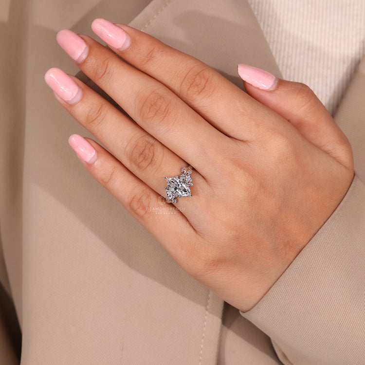 Cluster diamond ring with marquise cut center.