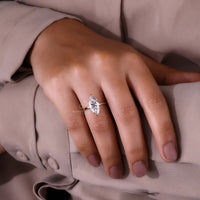 Yellow gold engagement ring with marquise cut diamond and handmade setting.