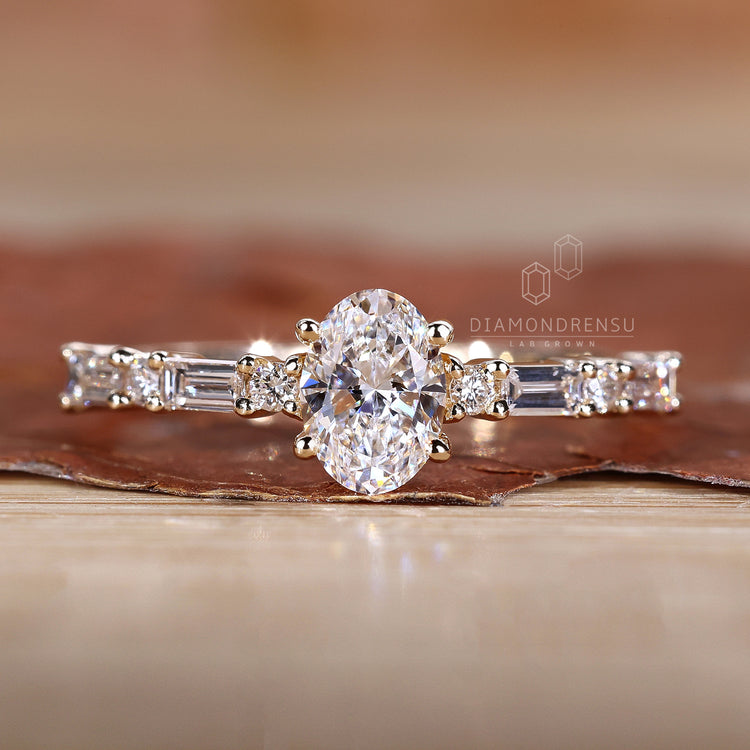 Oval diamond ring featuring side stones in pavé style.