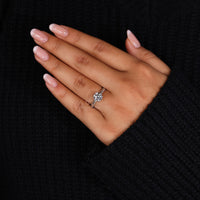 Prong setting ring with round diamond in rose gold knife edge design.