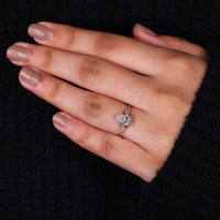 Kite cut side stones ring set in 3 claw prong setting ring.