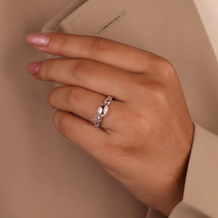 Prong setting ring with oval rose cut diamond and side stones.